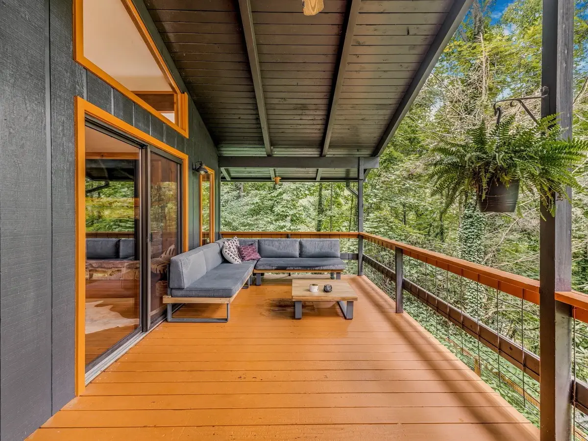 Covered deck with outdoor seating among the trees