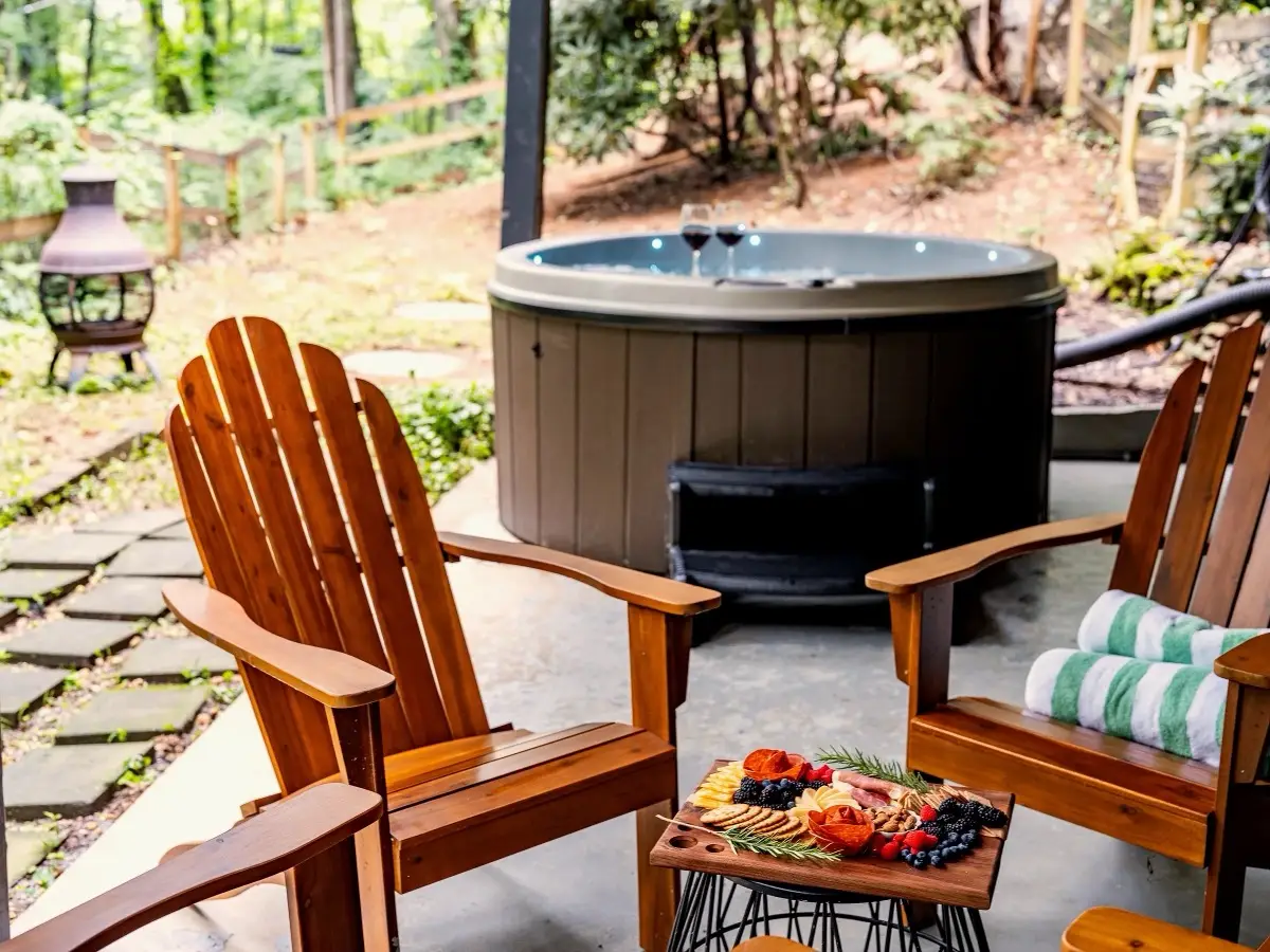 Hot tub with Adirondack chairs and a cheese board