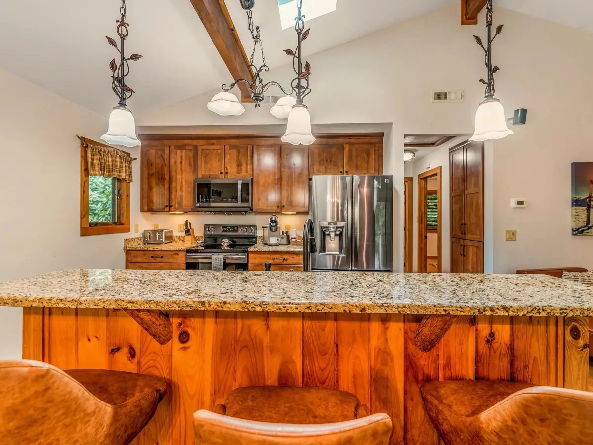 Kitchen island with pendant lights and barstools
